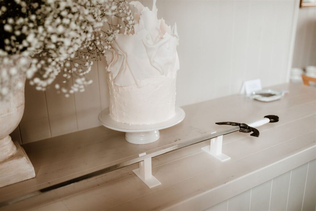 Catalina-and-Charles-Wilkinson-Wedding-Cake-Modern-Gypsophila-Urn-Sculptural-New-Zealand-Little-Tart-Bakery-Stationery-White-Spanish-Inspired-Sword-Cotton-Wild-Folk-Photography-Mudbrick