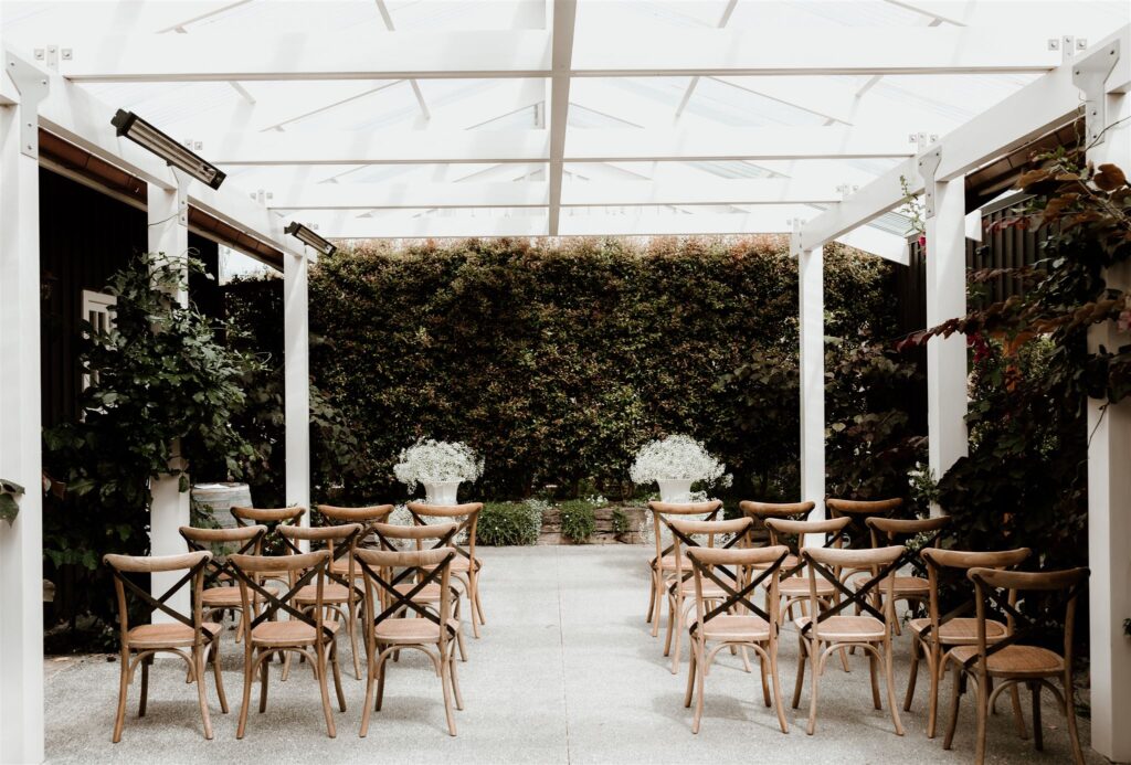 Catalina-and-Charles-Wilkinson-Wedding-DIY-Wedding-Gypsophila-White-Urn-Cross-Back-Chairs-Spanish-Inspired-Mudbrick-New-Zealand-Wild-Folk-Photography